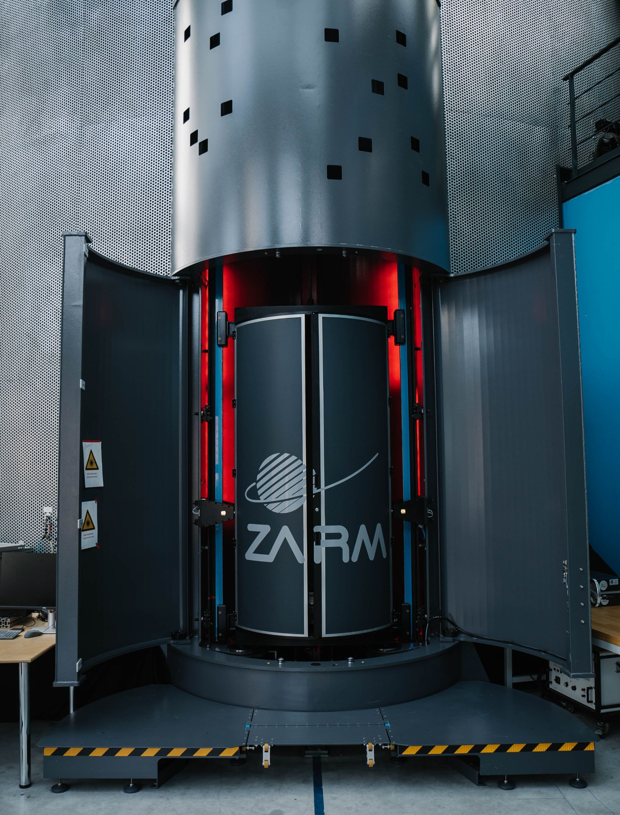 The GraviTower Bremen Pro with its outer doors open, showing the rail-guided slider that acts as the drag shield and the experiment capsule inside it.