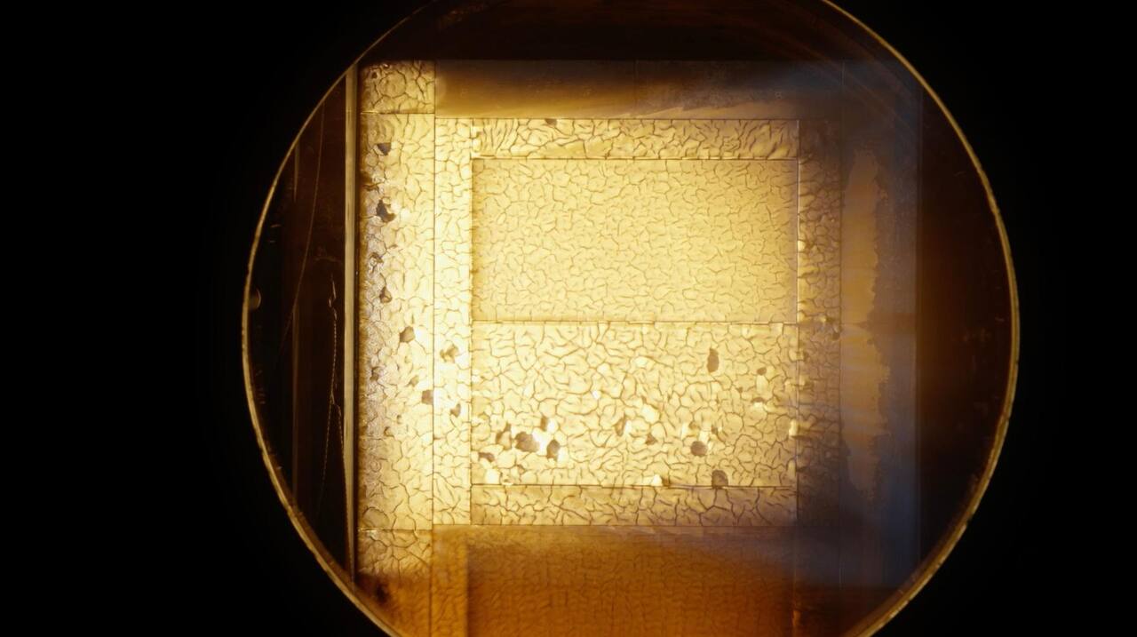 A test block of Avcoat undergoing heat pulse testing inside an arc jet test chamber at NASA ARC, December 2023.