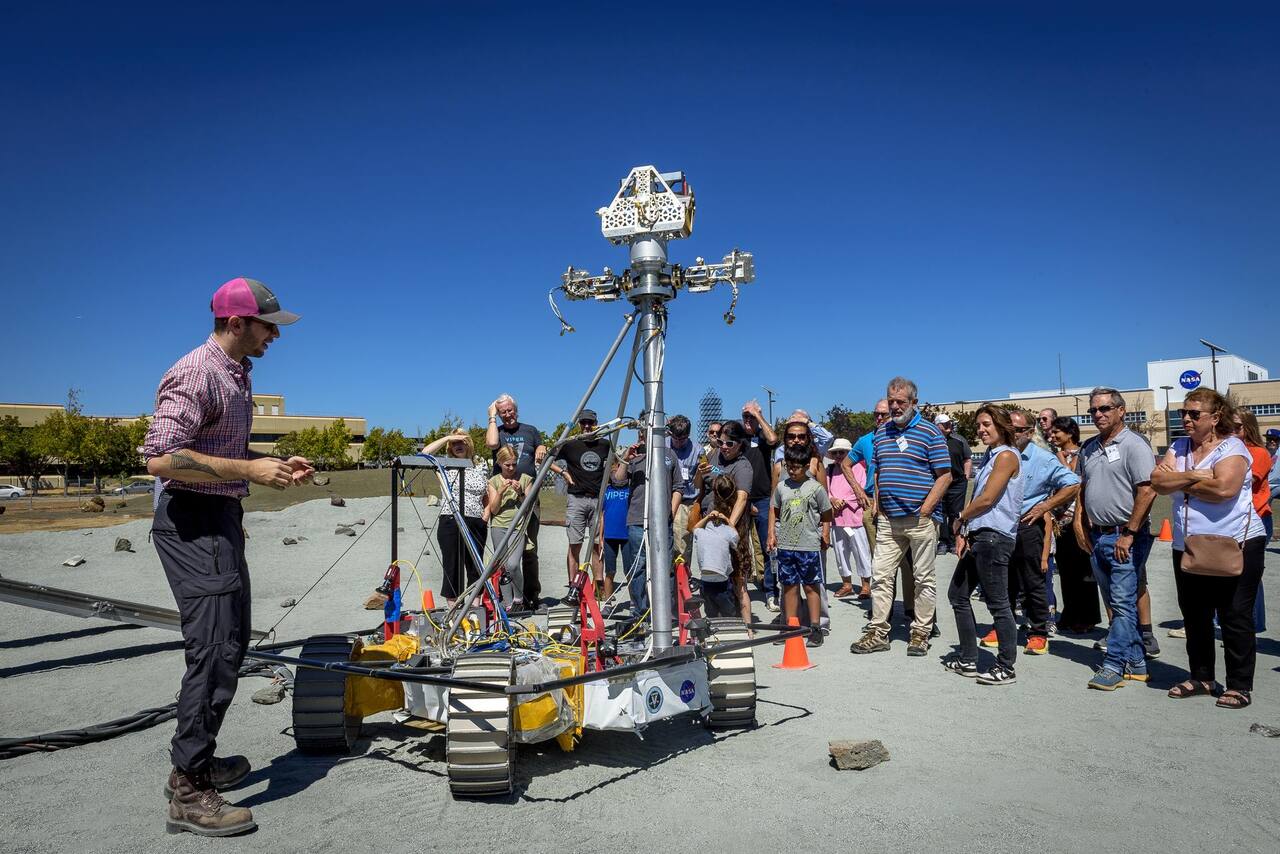 MGRU3, the weight-equivalent mobility and navigation test platform for VIPER, on the Roverscape surface. The graded crushed-rock terrain and scattered rocks are the test surface itself