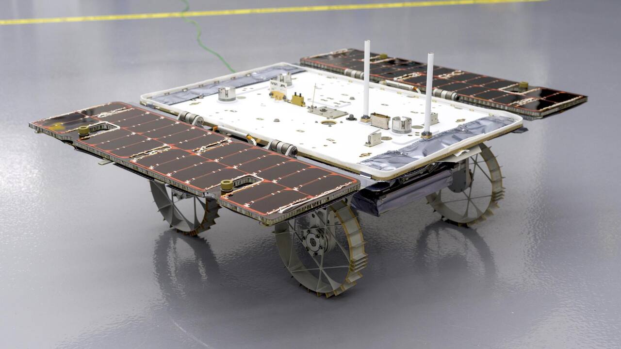 A completed CADRE rover in the JPL clean room on 26 January 2024 with its solar panel opened. Each of the three flight rovers is about the size of a carry-on bag and carries four wheels, the stereo camera pair used for onboard traversability mapping, and one element of the multi-static ground-penetrating radar