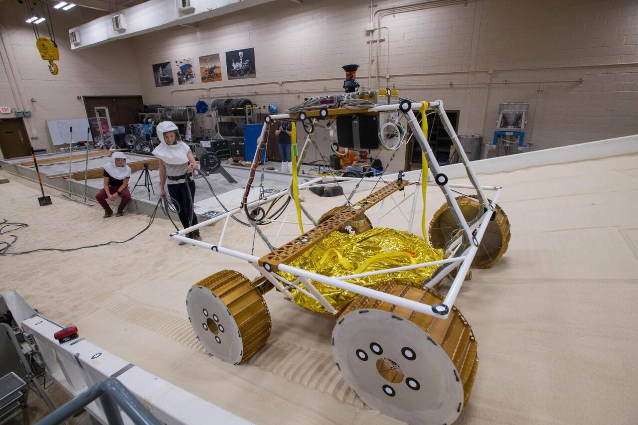 An engineering model of VIPER under test in the Simulated Lunar Operations Laboratory on the large adjustable soil bin, October 2019.