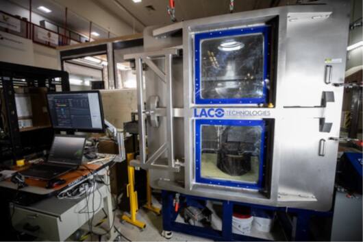 The ASSIST chamber in the GMRO high bay, front door closed, showing the two 0.5 m square viewports through which the interior is observed.