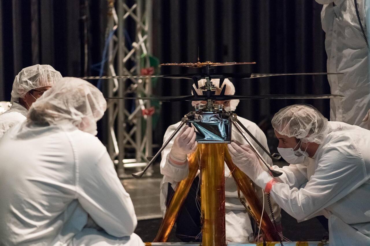 NASA Mars Helicopter team members working on the flight model inside the Space Simulator, a 25-foot-wide vacuum chamber at NASA JPL, 1 February 2019.