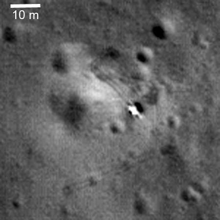 The Luna 21 lander on the floor of Le Monnier crater with the Lunokhod 2 wheel tracks running away from it, imaged from orbit by the Lunar Reconnaissance Orbiter. The tracks are visible because the wheel grousers disturb the regolith, and it is this track record that supported the 2017 remeasurement of the traverse at 39.16 km