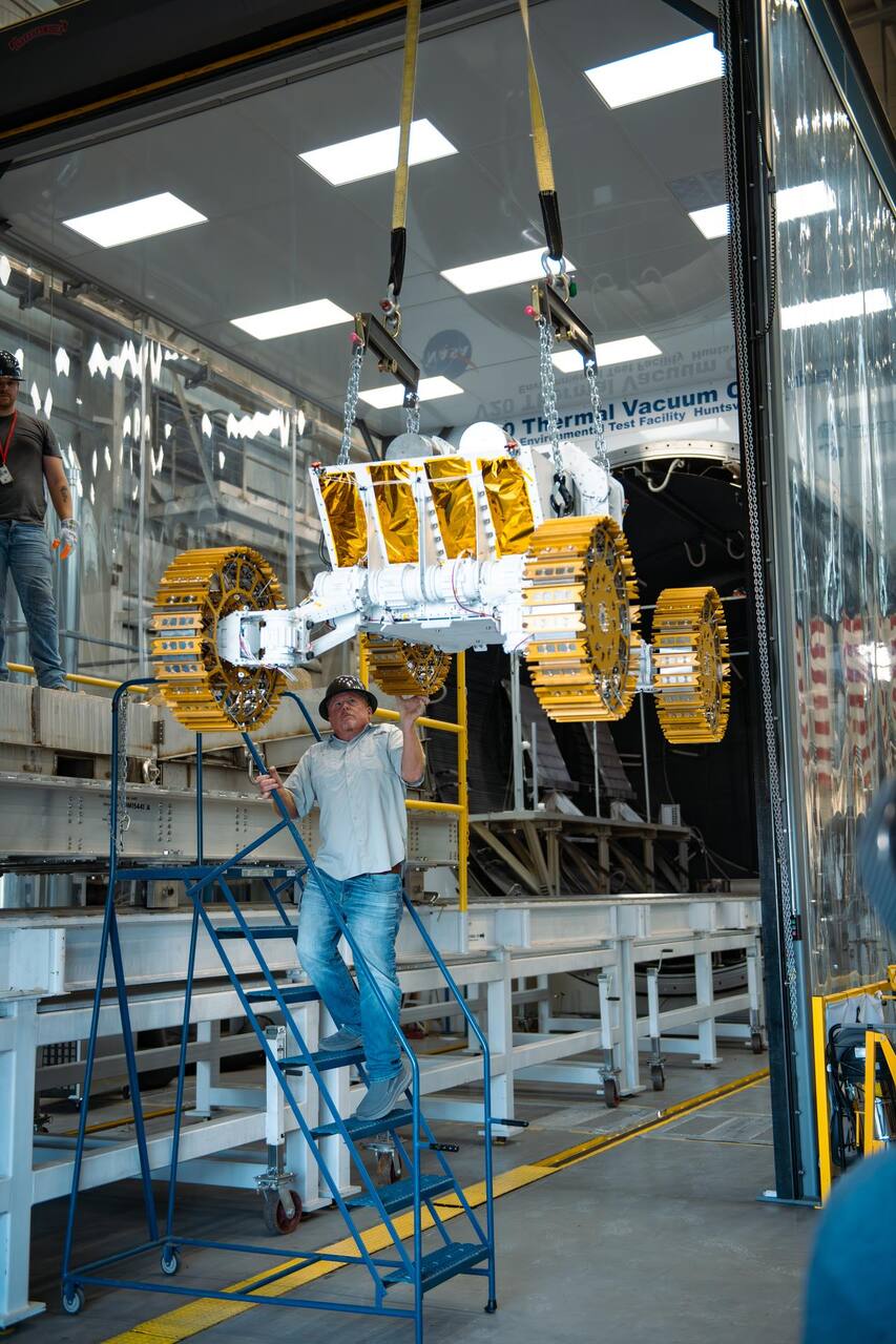 Environmental Test Facility employees at NASA MSFC working with the Starpath team on 30 July 2025 to maneuver their rover onto the platform that slides it into the 20-foot thermal vacuum chamber.