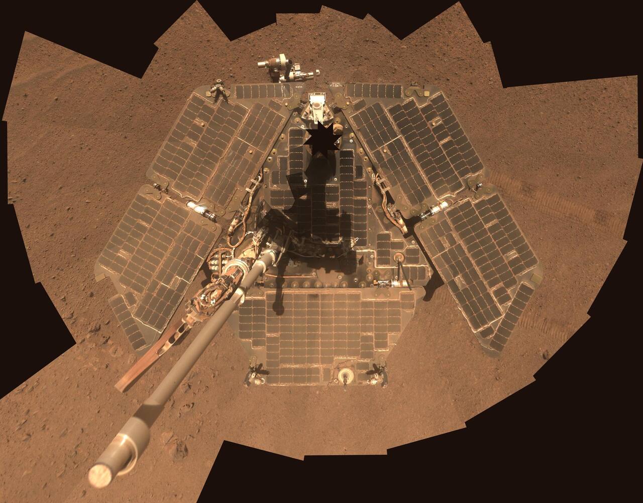 Opportunity self-portrait taken with the Pancam mast camera in late March 2014, after wind removed much of the accumulated dust from the solar arrays. The 1.8 m span of the triple-junction solar array dominates the deck, with the rocker-bogie suspension and the 0.254 m wheels below it