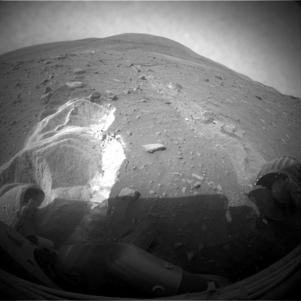 Spirit's front hazard avoidance camera view on sol 1899, 6 May 2009, after two weeks of extrication attempts at Troy had partially buried the wheels. The wheels have cut into the soft material that trapped the rover, the same mechanism by which the dragged right front wheel had earlier exposed near-pure silica