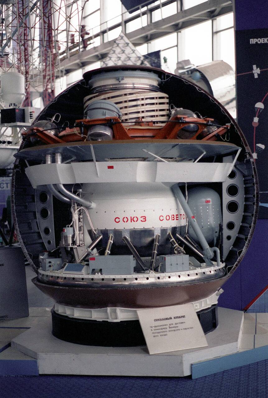 Life-size cut-away model of a Venera-type descent vehicle at the Exhibition of Achievements of the National Economy in Moscow. The section shows the spherical thermally insulated pressure vessel and the internal equipment deck it carries, the arrangement whose insulation mass and pre-chilled starting temperature set the fixed surface lifetime